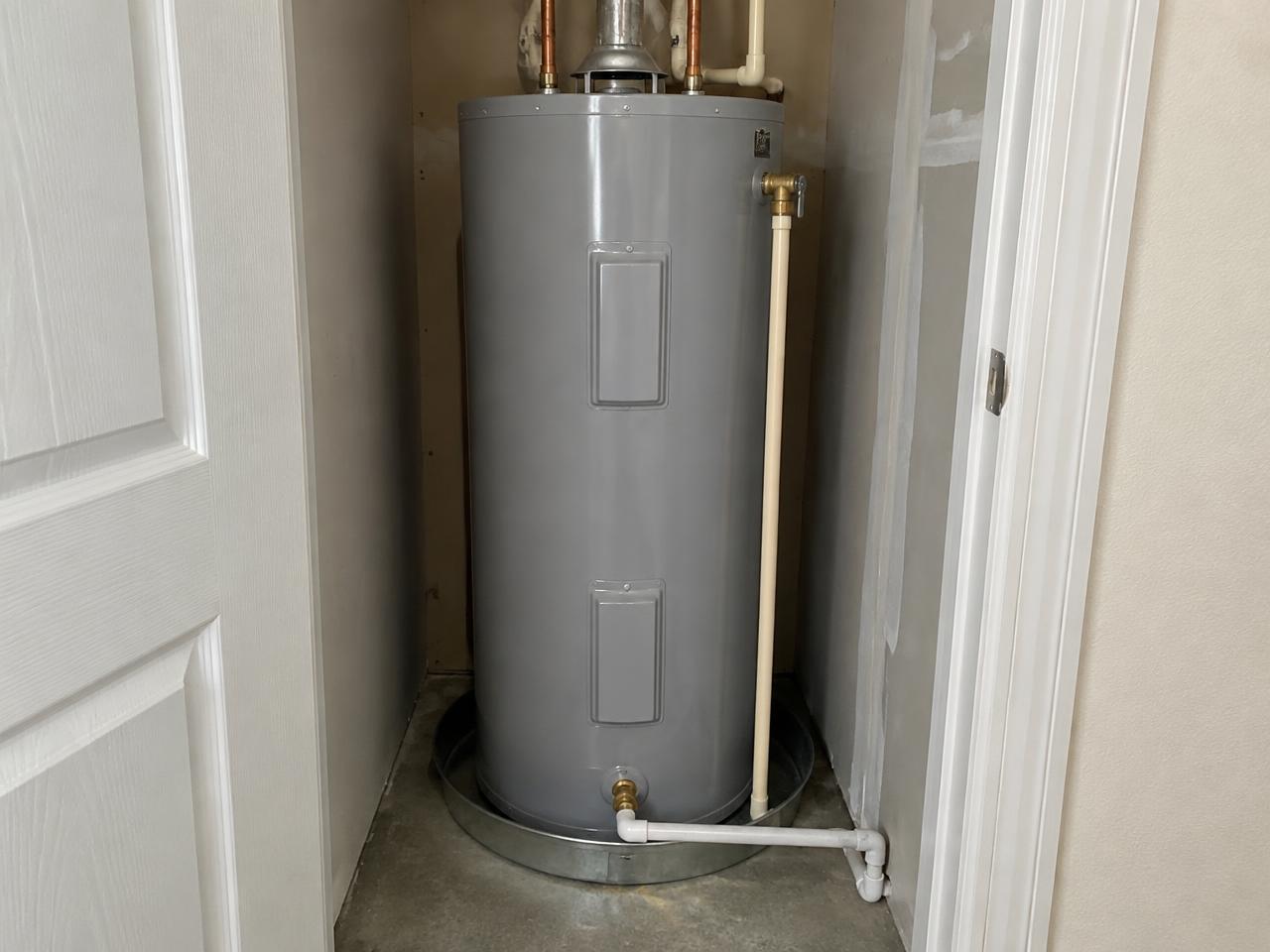 Drop cloths and drain pan set before a water heater replacement